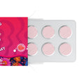 Pink pills in a blister pack with a colorful box on a white background