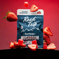 A Picture of strawberry desert stardust magic mushroom gummies from Road with strawberry flavoring and strawberries and gummies gravitating around the product picture. 