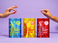 Three MshrooM FX Extra Strength Bulk Mushroom Gummies 50 count bags in Blue Razzberry Mango and Strawberry displayed side by side on purple background with hands holding individual gummies above each bag showing vegan gluten free and no high fructose corn syrup badges